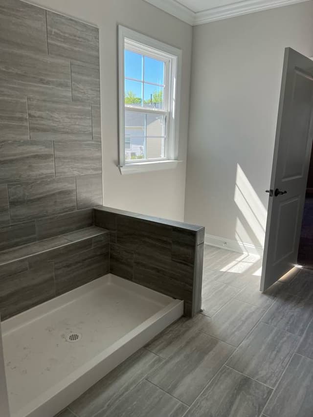 newly remodeled bathroom with wood laminate and newly installed window in minnapolis minnesota by midwestbathandshower