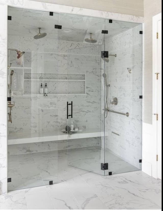 textured luxury walk in shower with glass doors remodeled in minneapolis minnesota 