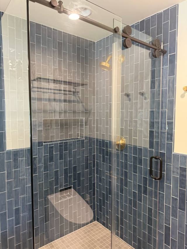 textured blue tile walk in shower backsplash remodeled in minneapolis minnesota by midwestbathandshower
