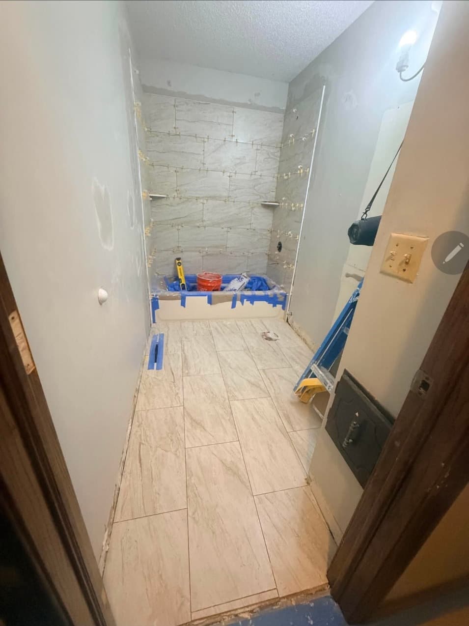 New large-format porcelain tile floor in a narrow Minneapolis bathroom