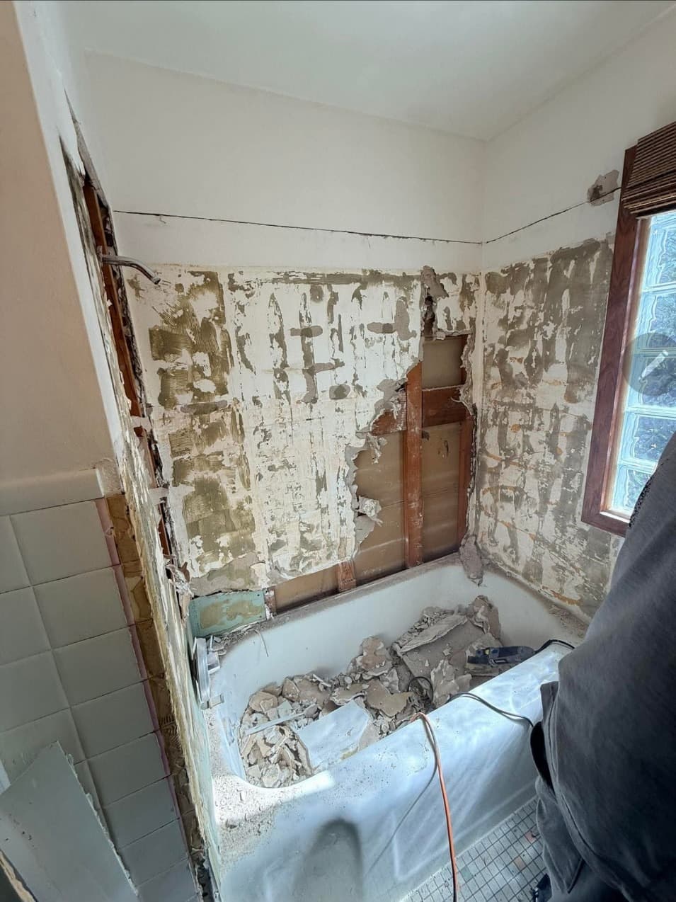 Old tile stripped from a bathtub wall during a bathroom remodel in Minneapolis, MN